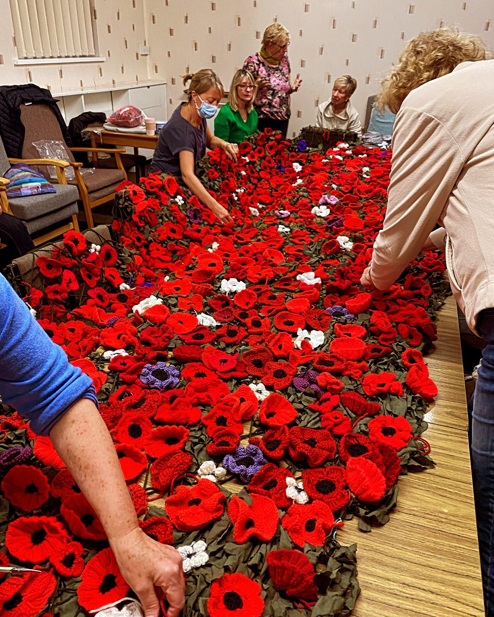 TwinRiversWI's tweet photo. Another productive evening on the poppy cascade. We have put around 1000 poppies on the netting now and have room for more. If you fancy having a go we would welcome poppies in red, white or purple wool. We are hoping to complete it next Wednesday 😀#Remembrance https://t.co/tYKHcVYOXc
