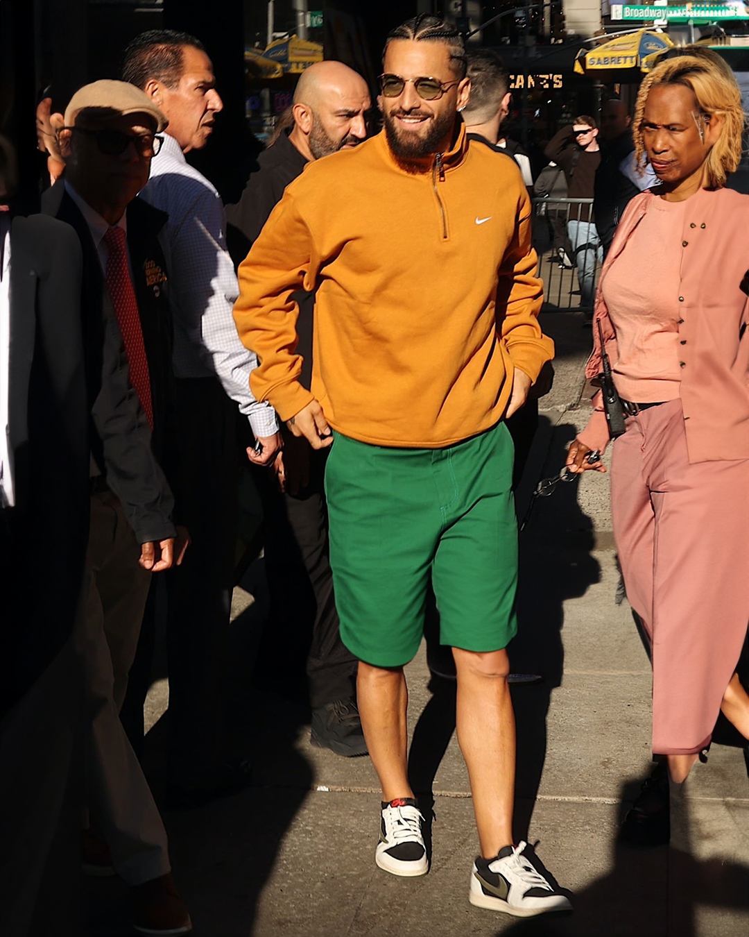 DAMAN Magazine on X Maluma s spotted meeting with his fans in the streets of NYC rocking the Travis Scott x Air Jordan 1 low tops in Olive paired with an orange Nike quarter zip