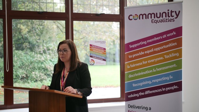 A photograph of Community Head of Education and Training, Tiffany Gillies, speaking at the 2023 Community Equalities Conference.