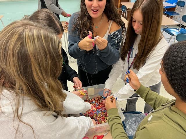 Some of our caring HELP International students re-purposing beads for future fundraising sales.  #internationalmindedness #CASexperience
