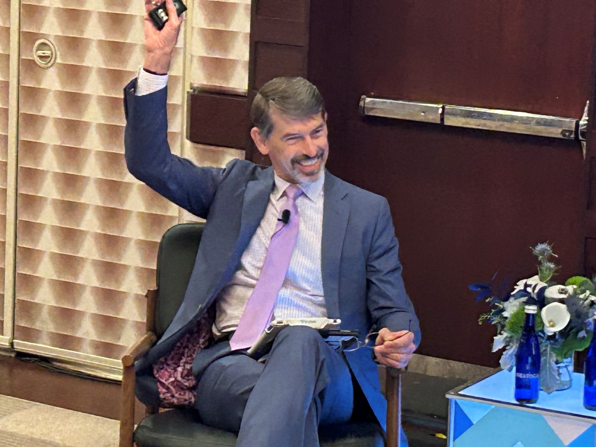 NovogradacNews's tweet photo. At the #NovocoOZ summit, Shay Hawkins with @ZoneFunds discusses congressional leadership as well as the legislative horizon for the incentive. The crowd laughs when he says, "There are a thousand ideas how to improve the opportunity zones incentive; 990 of those are bad." https://t.co/dk3ZF0C7QO