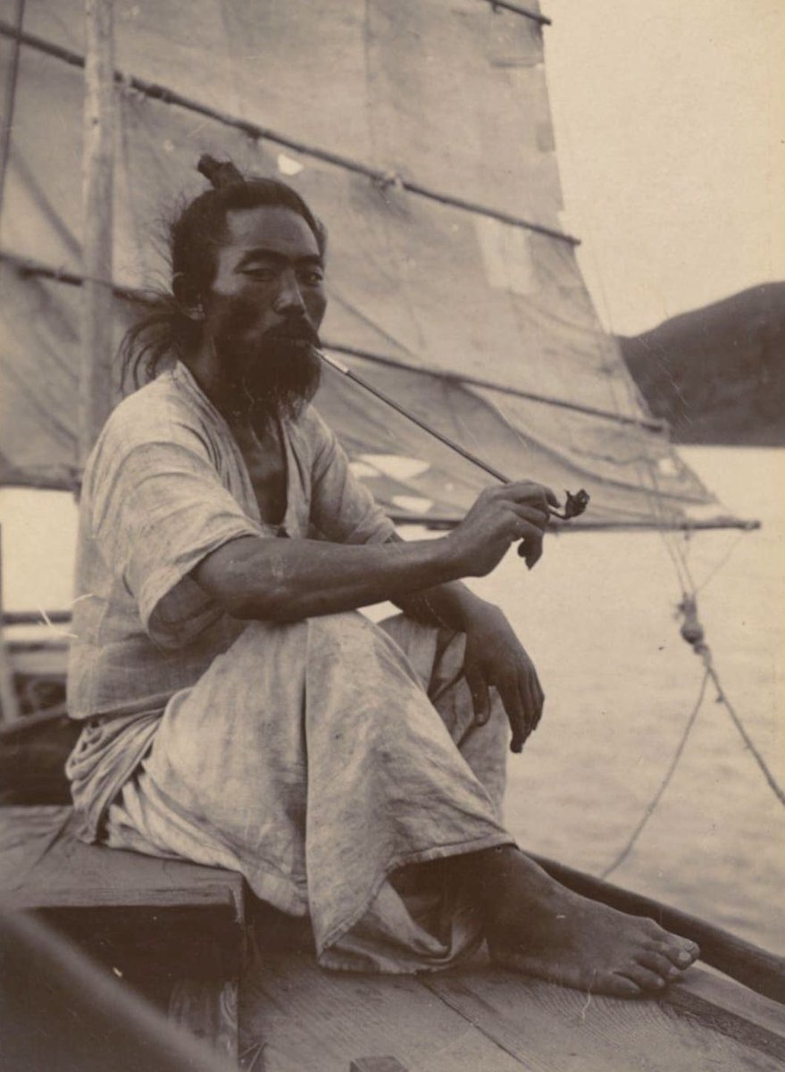 A Korean sailor takes a break from transporting cargo and people by sitting under the shadow from the sail, smoking from his long bamboo pipe. He wears cool hemp clothes, 1904.

Six years later, in 1910, Japan would colonize Korea and conduct an all-out war against Korean