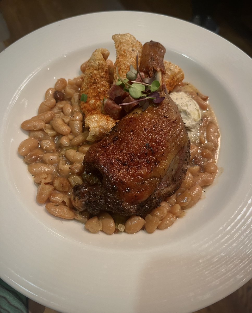 Dive into deliciousness 🦆 
..  ..  ..  
Duck Confit Cassoulet || Joyce Farms Duck Leg Quarter, Cannellini Beans, House-Cured Bacon, Orange-Herb Salame, Sage-Peppercorn Cream, Espelette Chicharron

#duckconfit #undercurrentgso #triadlocalfirst #dgso #greensboronc #downtowngso