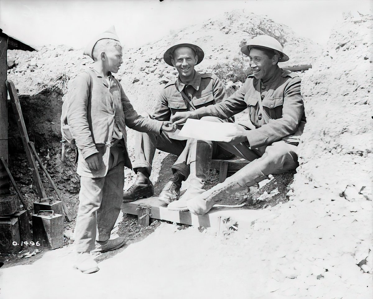 Legendary Canadian runner, Tom Longboat, purchasing a newspaper from a French boy in France in June, 1917 during WWI. Longboat was an Onondaga distance runner from the Six Nations Reserve near Brantford, Ontario and arguably the best Canadian athlete of the first half of the 20th