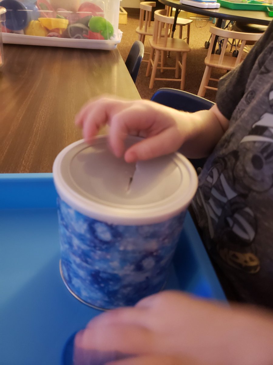 Working on our pincer grip and naming objects and colors with "put in" tasks.