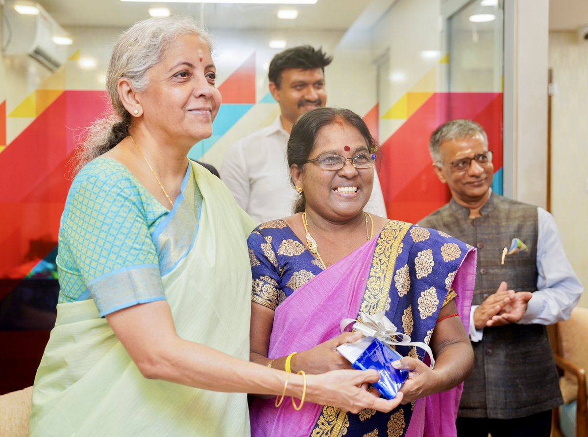 FinMinIndia's tweet photo. After the inauguration, FM. Smt. @nsitharaman interacted with the new branch officials and distributed passbooks to new customers, besides filling the visitor’s book in Trincomalee, Sri Lanka. (2/2) https://t.co/QN8lhYqpsi