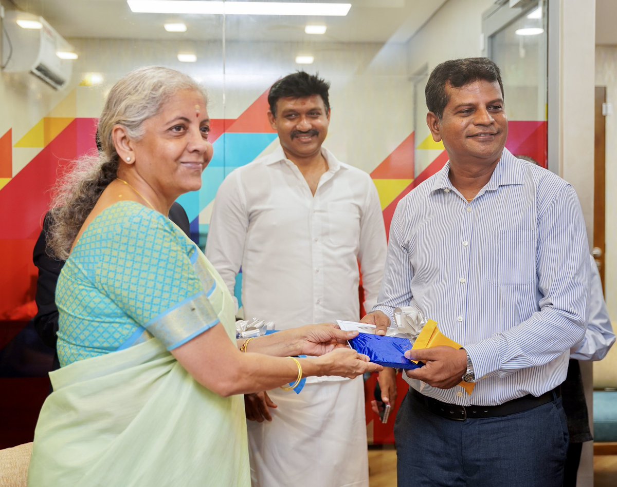 FinMinIndia's tweet photo. After the inauguration, FM. Smt. @nsitharaman interacted with the new branch officials and distributed passbooks to new customers, besides filling the visitor’s book in Trincomalee, Sri Lanka. (2/2) https://t.co/QN8lhYqpsi