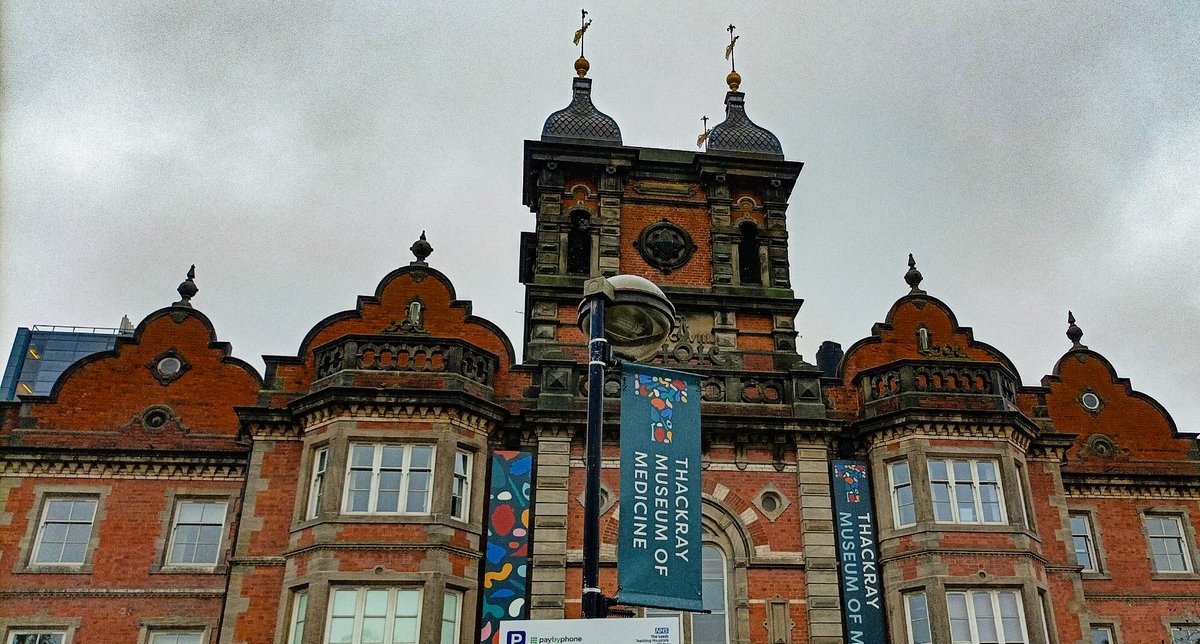 Image descriptions:
1. Amelia Silver with co-creators Enas and Lucy.
2. Dressing Disability signage - blue poster, with white text and pink hanger graphic.
3. Object text description - Stoma purse and radar key.
4. Thackray museum building exterior on PV night 
📸 <a href="/KarlAntMercer/">Karl Anthony Mercer</a>