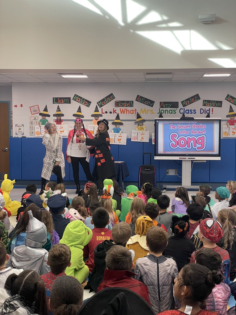 SlocumCSD's tweet photo. Mrs. Dluginski kicked off Halloween with a K-2 assembly about the Secret Stories! She had a little help from Slocum faculty and staff. Grades K-2 finished the assembly by singing The Secret Stories Better Alphabet Song that they have all been practicing in class! #SlocumShines https://t.co/sy1FClGLRm