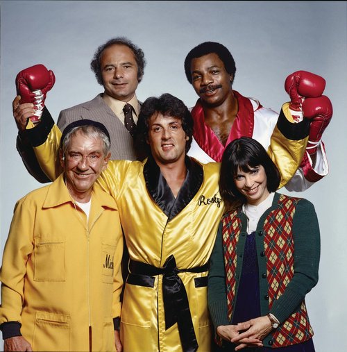 A portrait from the film set of Rocky II: Sylvester Stallone as Rocky Balboa, Burgess Meredith as Mickey Goldmill, Burt Young as Paulie, Carl Weathers as Apollo Creed, and Talia Shire as Adrian. Los Angeles, California. November 1978. #NeilLeifer #Photography #Rocky