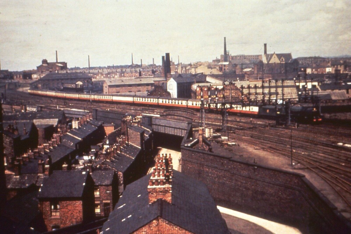 Over the rooftops of Preston, Camden Coronation 46237 City of Bristol looks quite at home at the head of a thirteen-coach express in 1952. Its casing removed in March 1947, 46237 was withdrawn from 12B Carlisle Upperby Shed on 12th September 1964 & sent to Arnott Young of Troon.