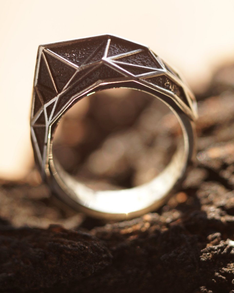 Pick your favorite photo style! the Quantum Ridge: Its polished piped edges, crafted from oxidized sterling silver, perfectly highlight the facets of this low-poly design. 
.
.
#artjewelry #uniquering #2022rings #jewelrydesign #darkluxury #brutalistjewelry #magickal #blvckfashion