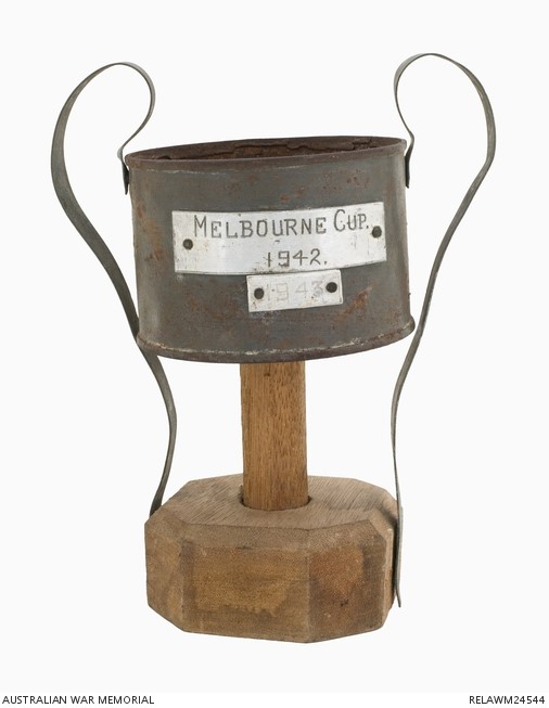 AWMemorial's tweet photo. To mark Melbourne Cup day in 1942, prisoners at the Sandakan POW camp held a 'race' with the winner awarded this makeshift 'Melbourne Cup'. The cup was awarded again the following year, this time at the Batu Lintang prisoner of war camp at Kuching in Sarawak. https://t.co/QO2uaDddJ6
