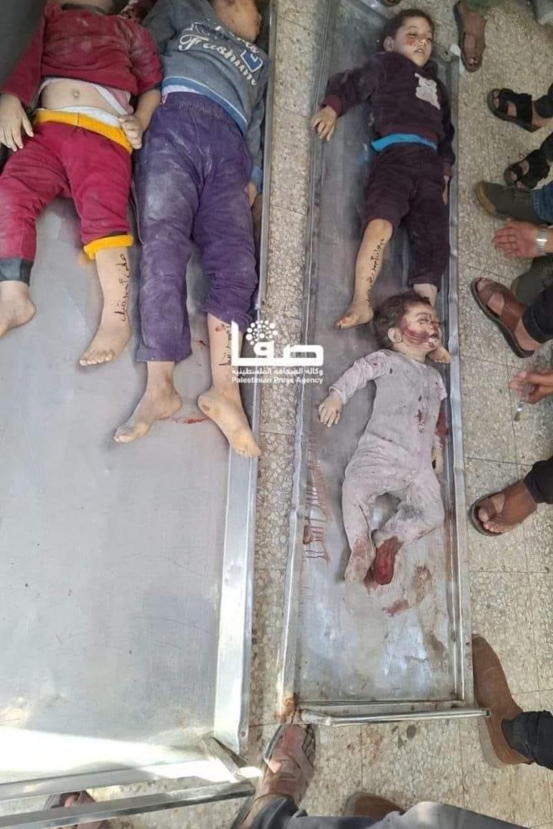 Emelia8z0's tweet photo. A message to the silent world: Don't overload Gaza's children beyond their capabilities. Yesterday they wrote their names on their hands and feet so they can be easily identified, and today they were martyred in the bombing of Gaza by Israeli occupation 💔
#Stop_the_bloodshed_in_Gaza 
#SavePalestineSaveHumanity