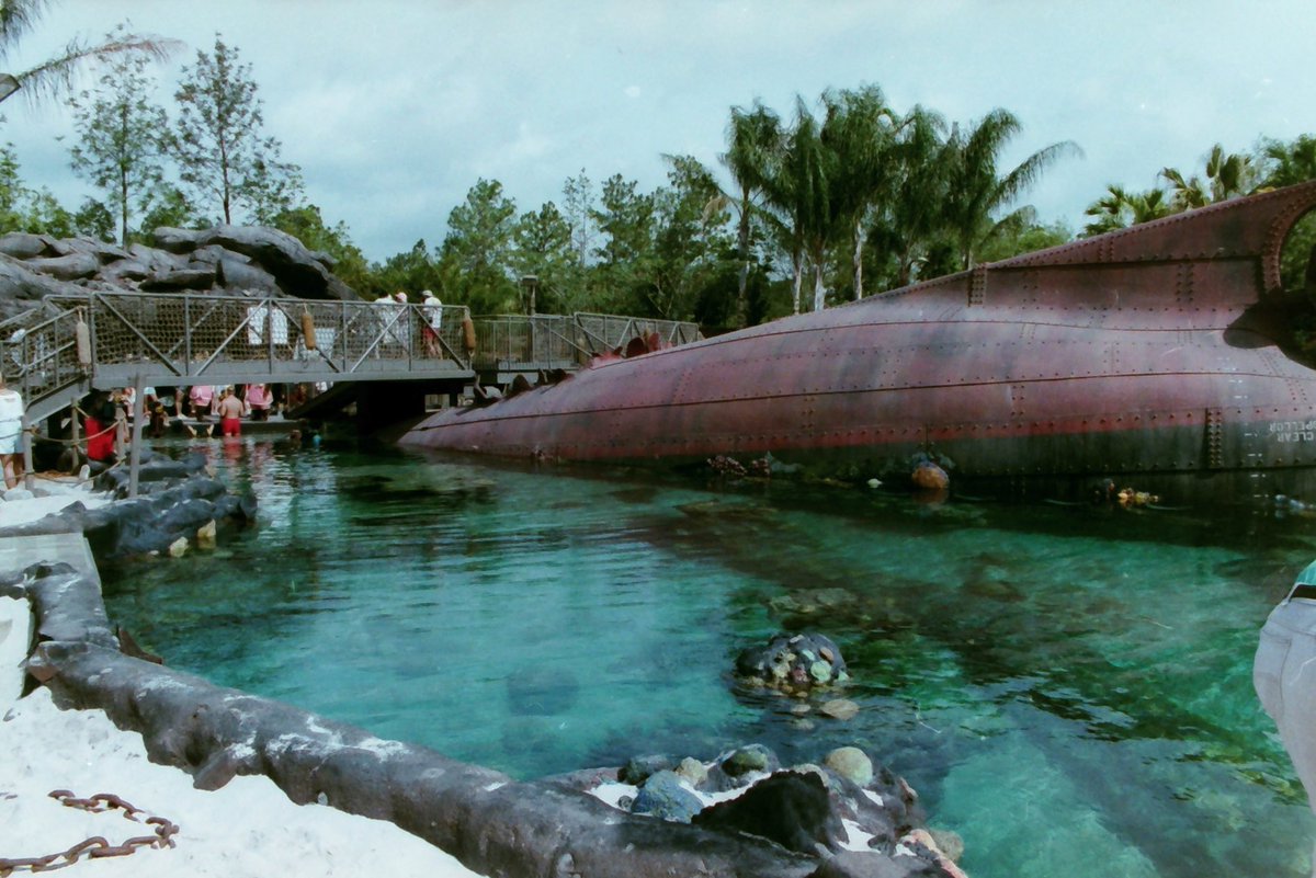 JimShull's tweet photo. Once upon a time when Typhoon Lagoon opened guests would swim in this pool with fish and harmless sharks.  Guests could watch from inside the rusty ship hull.  The hull ramped downward and was dark. Unique experience and now closed.  #TyphoonLagoon #WDW https://t.co/Ts3zwJiQTJ