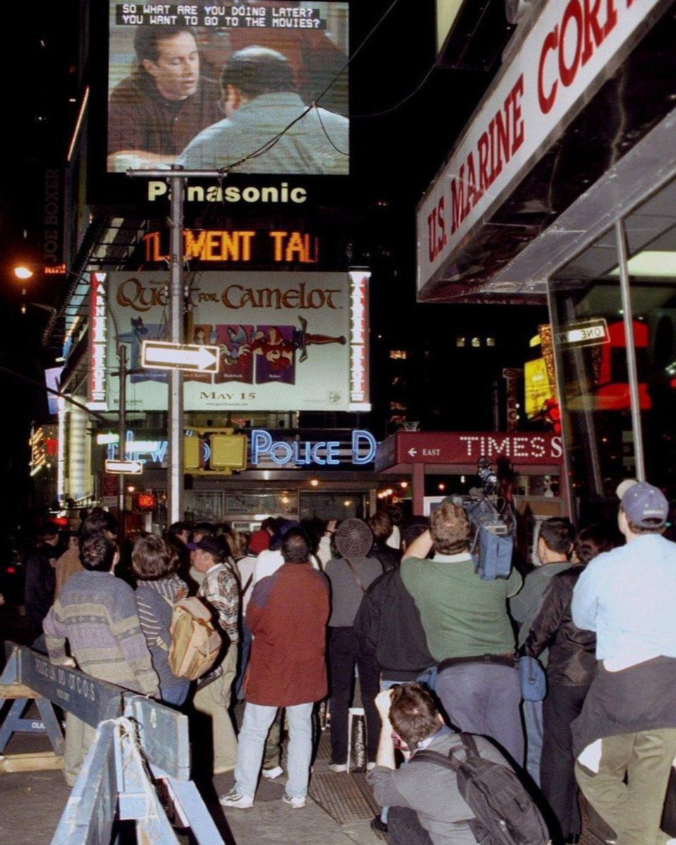 People stop to watch the “Seinfeld” finale in Times Square in 1998.