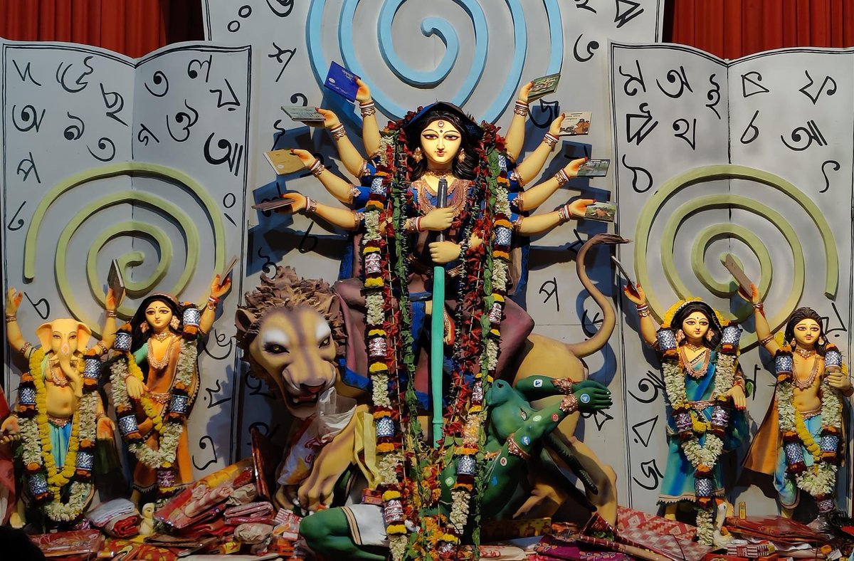 abhijit_MLab's tweet photo. Durga Pandal in Neelpukur Kolkata. Their theme is, yes, books. Hence, the pandal is decorated with books and books. Even the deity is carrying books instead of weapons. And who doesn’t know, pen is mightier than sword. 
PC: Prof. Subhradip Ghosh, IITG. https://t.co/rODULjlLgO