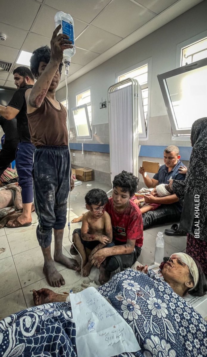 EyeonPalestine's tweet photo. Palestinian children sit next to their mother who receives treatment on the ground of the Shefa hospital after they were injured by an Israeli air strike in Gaza.  23.10.23 https://t.co/dz9t4tjObt