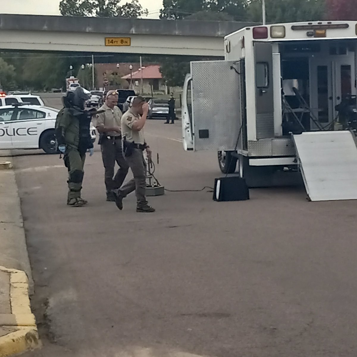 cspauldingMPhx's tweet photo. Oklahoma Highway Patrol troopers bring suspicious package to their truck. The package was found behind federal building on Main Street. https://t.co/9t8j6qRKay