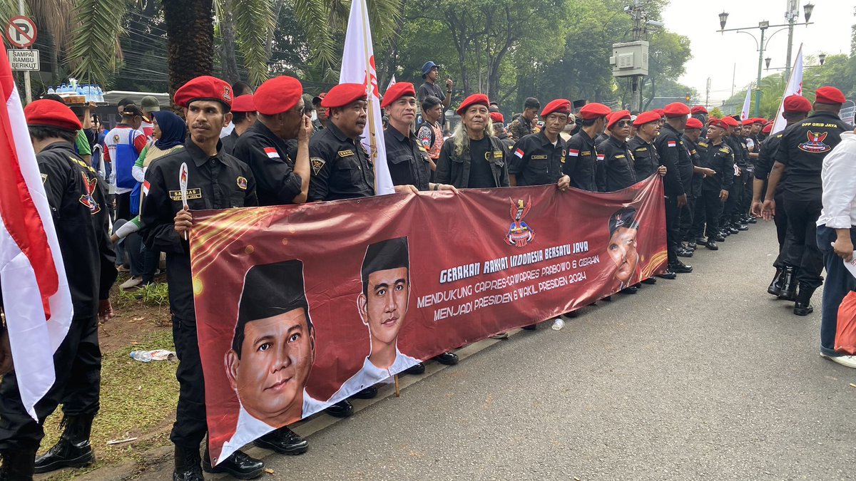 Supporters of presidential hopeful Prabowo Subianto and his running mate Gibran Rakabuming Raka gather outside the General Election Commission as the pair register their candidacy for the Indonesian presidential election next year.