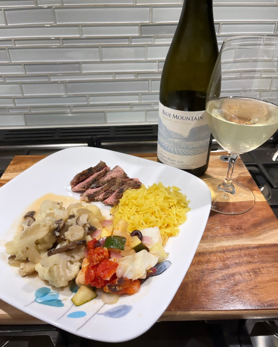 Mediterranean inspired baked cod + rib eye grilled on <a href="/webergrillsca/">Weber Grills Canada</a>, caulif mushroom, turmeric inspired basmati rice, paired with a nice @bluemtnwinery Pinot blanc, sorry wrong wine glass #homecooking #bbq #foodandwine #wine #cooking #fish #surfandturf #ribeye #steak #bcwine
