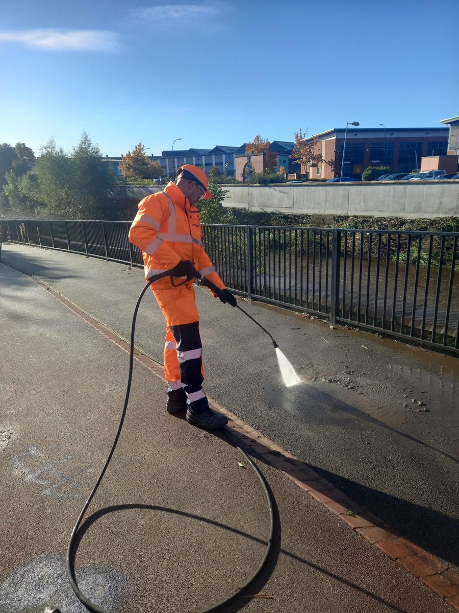 One of our operatives jet washing the mud and silt from the footway and cycle path on Five Weirs walk alongside the River Don.