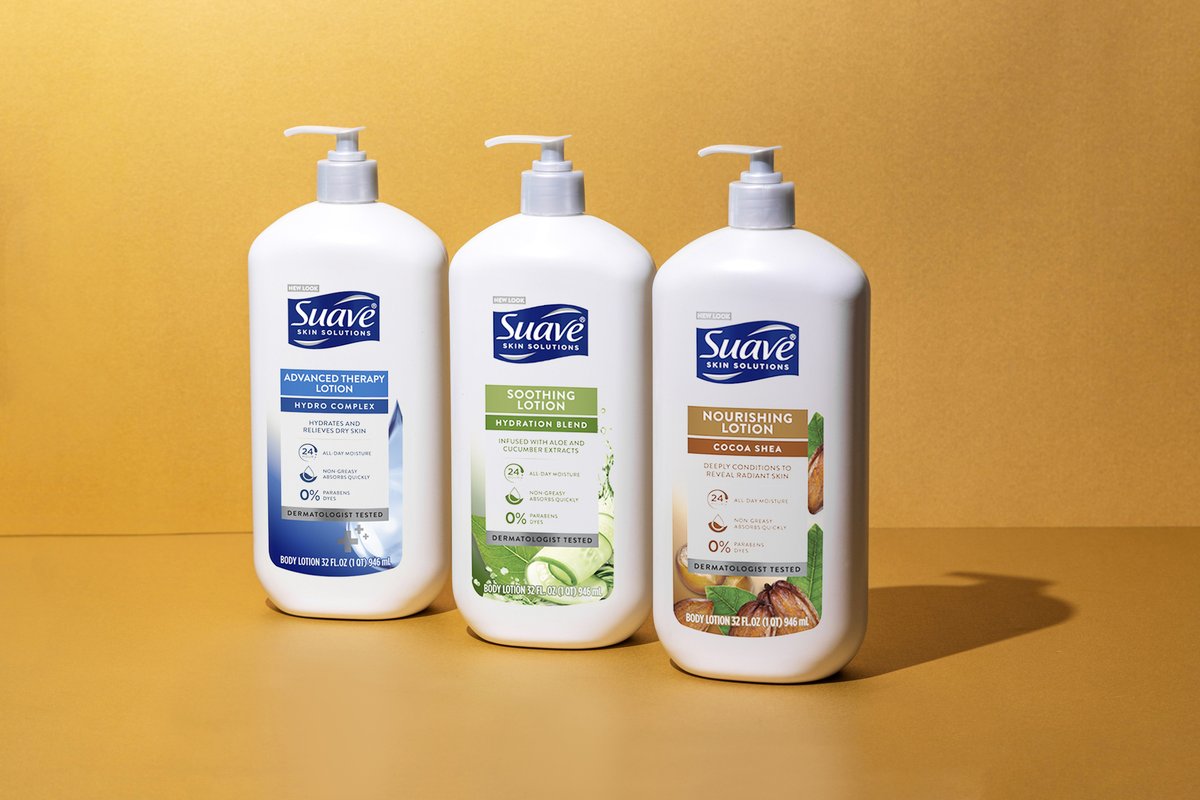Bottles of Suave Advanced Therapy Lotion, Soothing Lotion and Nourishing Lotion on an orange background.