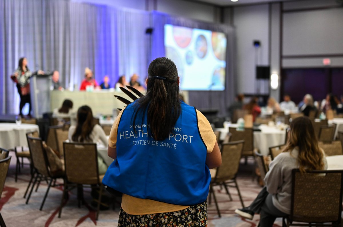 A health support worker watches and listens to the panel as they share information about the mental wellness supports and initiatives for Indigenous Peoples. #IMWsummit23 #MentalHealth #IndigenousHealth