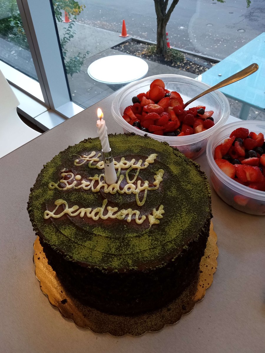 DendronC's tweet photo. My lab has a fun birthday cake tradition, and everyone pretends like it's a surprise for the birthday person, who always plays along. My PI got a cake shaped like a tree section and added matcha to the top to give it this mossy look, and brought berries to go with it! https://t.co/Un6OAGNzIE