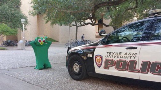 reactjpg's tweet image. texas a&amp;amp;m university police arresting gumby on his knees in front of the car hands behind his head