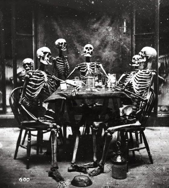 A group of skeletons smoking. Photographed in 1865.