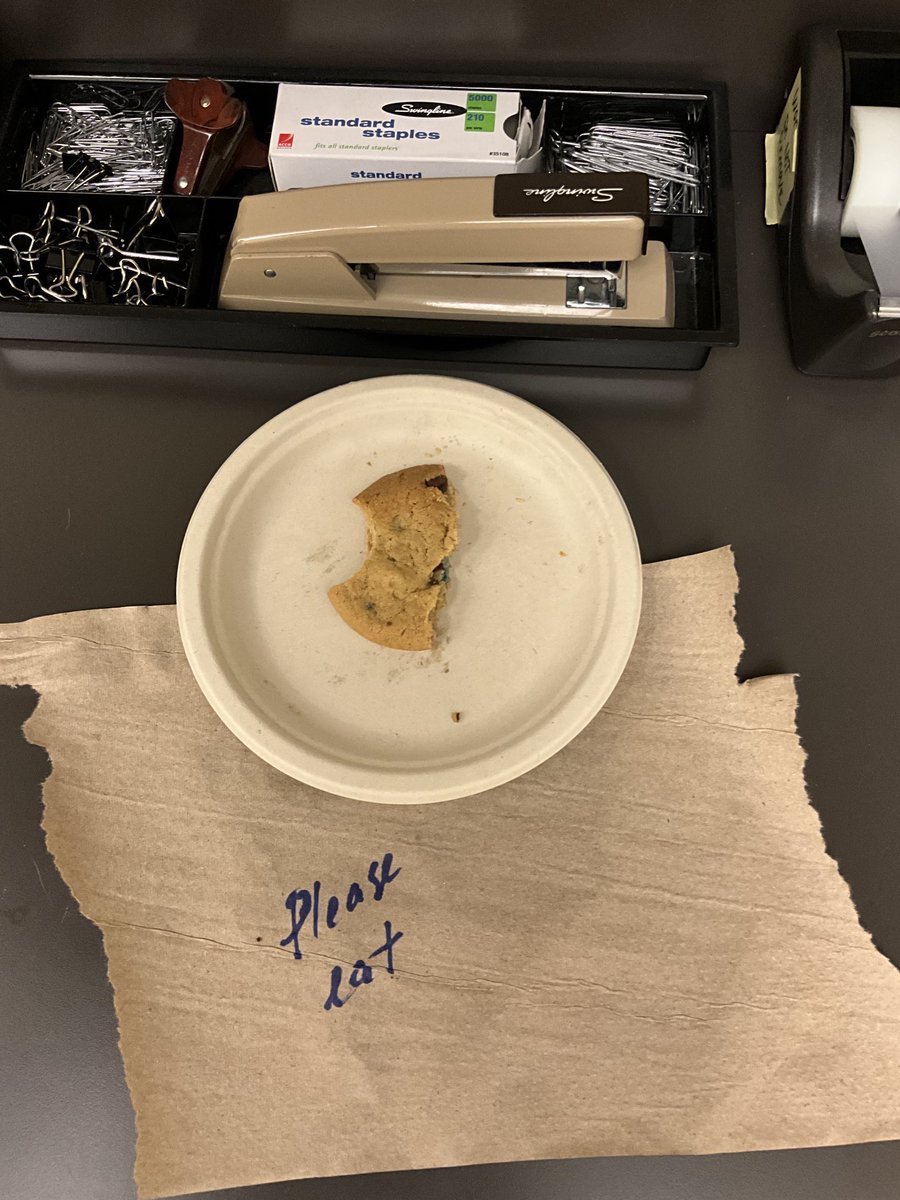 ProfASLitwin's tweet image. So many questions about this thing I found in the coffee/copy room just now. Did the person initially leave an entire cookie, thinking that someone should simply claim it in its entirety?Did the person who took the bite think that others would come take bites of their own? Etc…