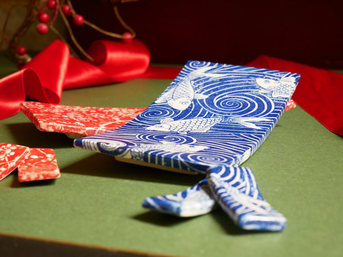 Explore our ceramic collection in our Museum shop! This beautiful sushi set with chopstick rests is designed by Piu Bose, a multi-disciplinary artist who lives and works in Bath. They are decorated with koi fish swimming through the elegant swirl design.