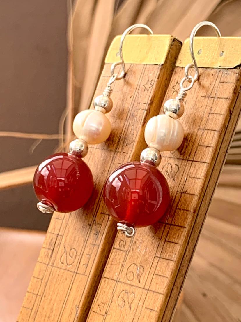 Pair of original handcrafted gemstone earrings, featuring fresh water pearls, red agate and comprising 925 Sterling Silver, offering a unique, elegant design, available for purchase via the Earrings of Gemstone Etsy store: etsy.com/uk/listing/144…

#redearrings #pearlearrings