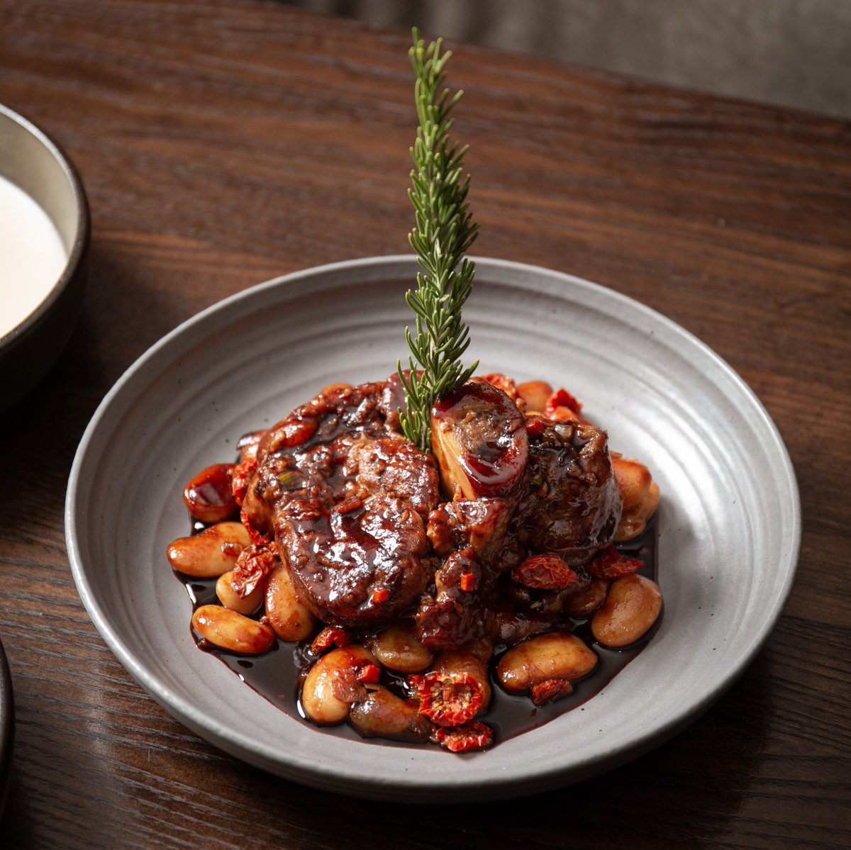 Veal Osso Bucco with white beans, pancetta, braised Thumbelina carrot, and red wine pearl onions. New on @GoldfinchTavern fall dinner menu: bit.ly/408UnmZ #seattle