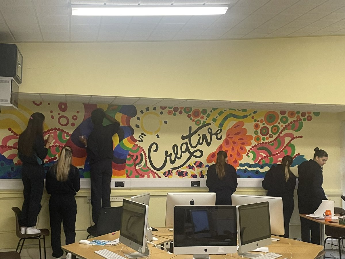 As part of our ‘Creative Schools’ programme, the art department launched a competition to design two murals for our Mac Lab Suite. Olha (TY) & Zahra’s (3rd year) designs were combined to create this wonderful piece! Mural two begins next term!