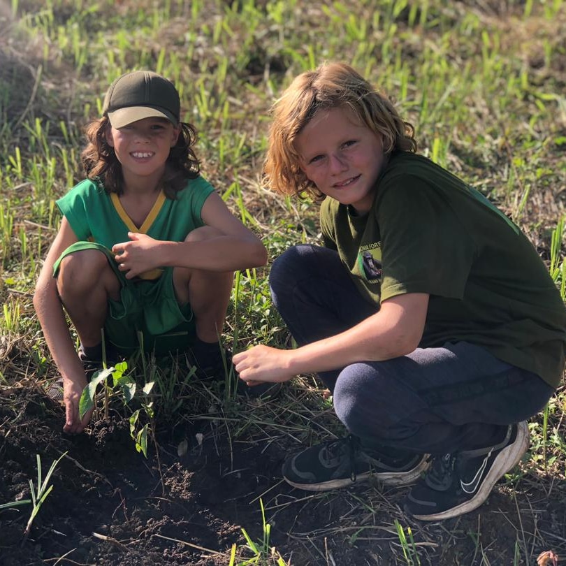 Two young boys planting trees at Bugoma Jungle Lodge in the project for ACBF 'Every5Acres', the project is to have a new home of chimpanzees and other primates. #Bugoma4Tourism