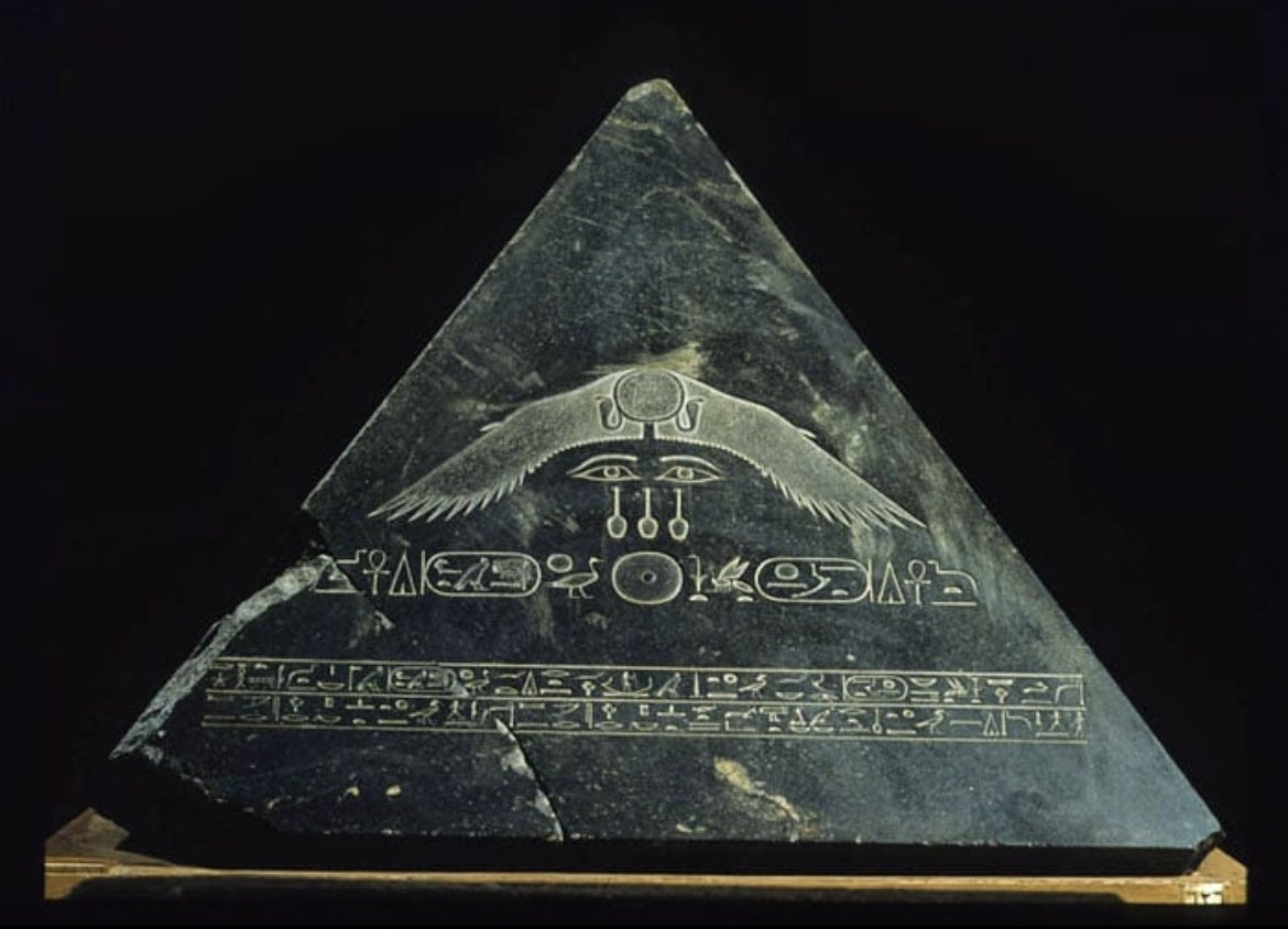 A rare intact pyramid capstone; it is one of the few known in existence. The capstone belonged to the Black Pyramid, which was built by King Amenemhat III, c 1850-1800 BC.

The hand carving shows a solar disc with two cobras and outstretched wings (sign of protection) on each