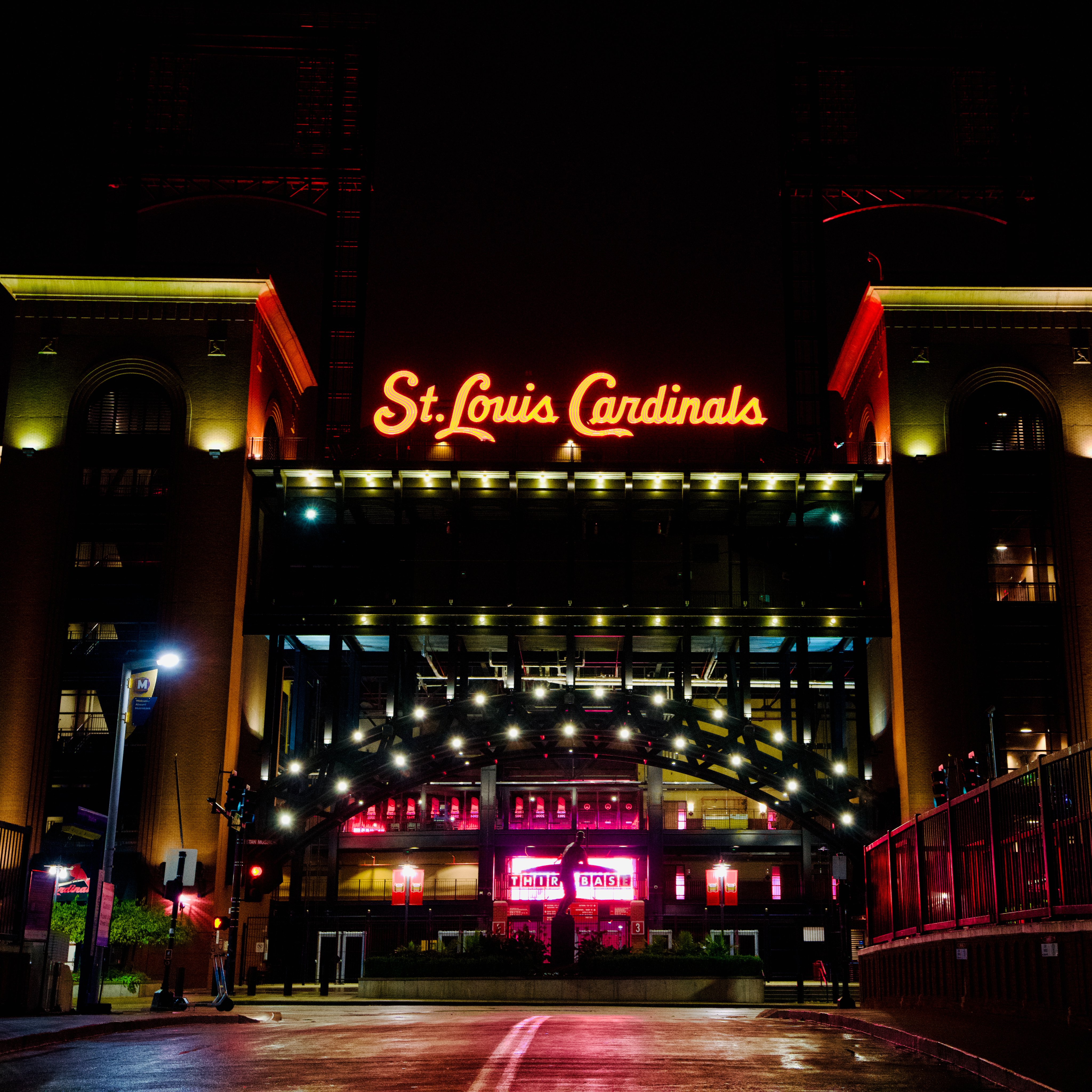 St. Louis Cardinals neon sign with downtown from Busch Stadium