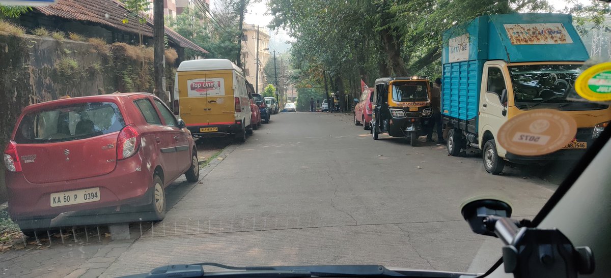 This entrance to KMC trunk road Bejai although there is clear no parking sign on the right side,royally people park and go ( most of the vehicles are parked overnight), everyday nuisance for the pedestrian who literally have to walk on the middle of the road. #whoisresponsible