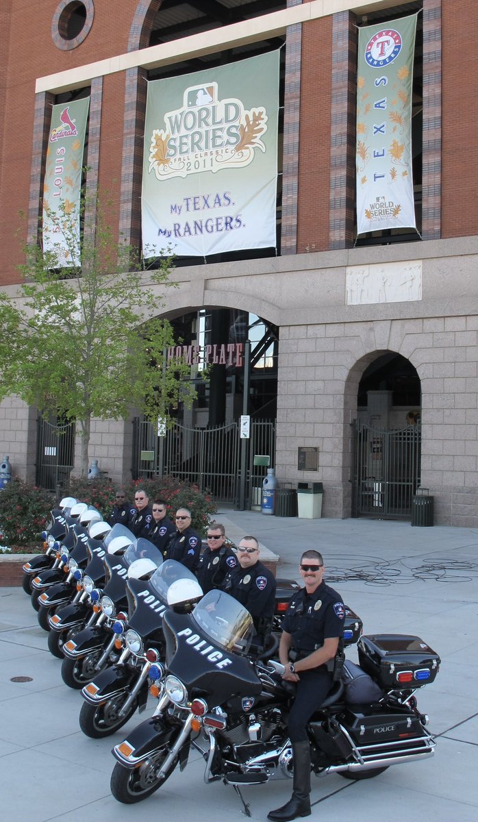cooktx's tweet photo. Looking at our @ArlingtonPD badges that we commissioned during the 2010 and 2011 World Series and came across this great photo of our motor team that I snapped with the #WorldSeries banner in the background. I noticed Officer Darrin McMichael at the top of the stack… what a great person who left behind a wonderful legacy. We will never forget Officer McMichael. 

I was a sergeant at the time and even though we couldn’t pull it off, we proudly wore these specialty badges for the @Rangers.