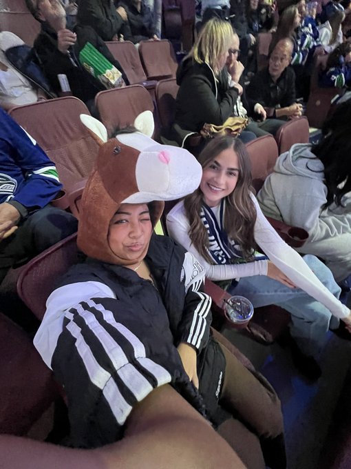 me and alli sitting in our seats i am wearing a horse hat for halloween