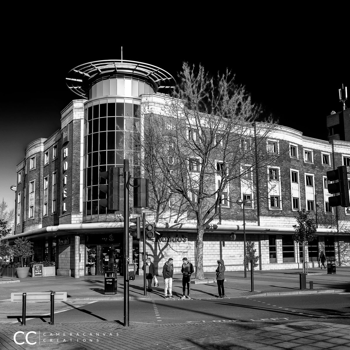 'Urban Life in Monochrome: Pedestrians at the IBIS Hotel Traffic Light'
#UrbanLife #BlackAndWhitePhotography #StreetPhotography #IBISHotel #CityLife #Pedestrians #CrossingTheRoad #Monochrome #Cityscape #trafficlight #London #England #BangladeshiPhotographers