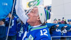 A photo of Bill Nye raising the 12 flag.