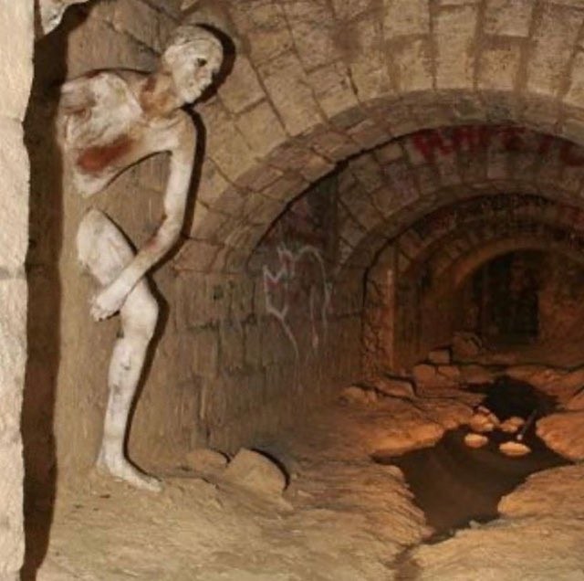 fasc1nate's tweet photo. The Le Passe-muraille (Passer-Through-Walls ) sculpture in the Paris catacombs

Carved by 'cataphiles' – the name for those who illicitly frequent the deeper catacombs – it was inspired by a French fairy tale about a man who misuses his power to walk through walls to steal and seduce. He loses his power mid-transition and becomes trapped.