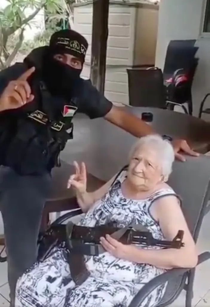 HassanShibly's tweet photo. What’s your best explanation for why the hostages are taking photos with their captor’s AK-47? https://t.co/DC6YL5mVH3
