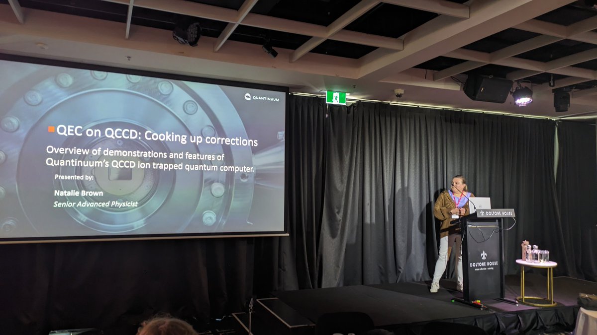 balopat's tweet photo. Natalie Brown showing off @QuantinuumQC QCCD architecture with also mid-circuit measurements used in QEC. It's cool to see ions running around the chip. Steane code paper (Ryan-Anderson etc al 2021) recommended (students especially) for experimental QEC proposal #QEC23 https://t.co/z7GYdAretz