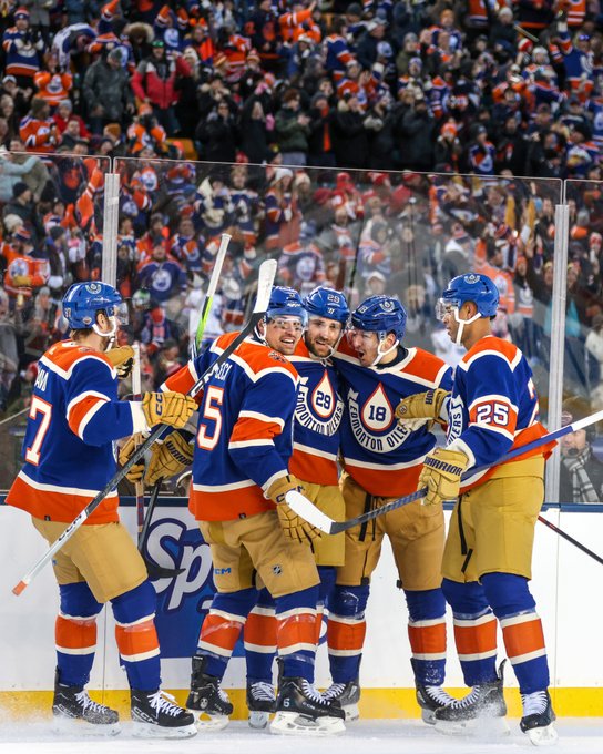 The Oilers celebrating a goal on the ice. 