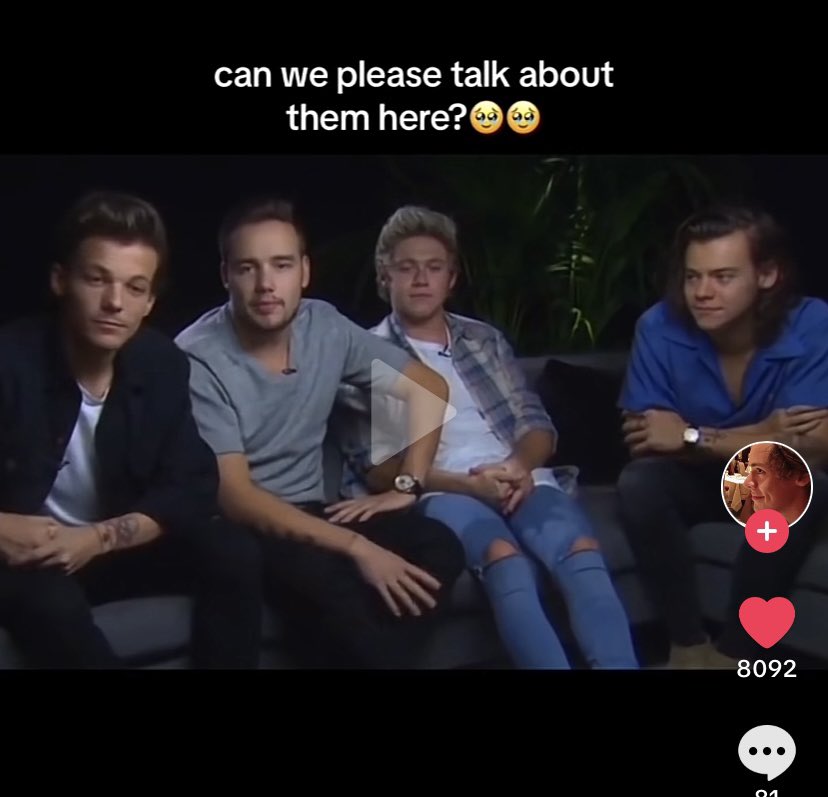 Louis looking in the monitor looking at Harry looking at him.