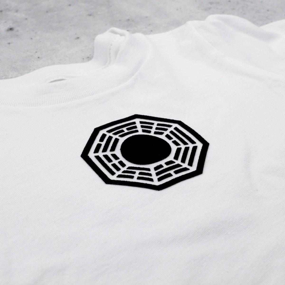 We also have a small batch of baby clothes printed right here on the island using HTV. The onesies have a smooth matte design and the grey and white tees use flocked vinyl so the logo is slightly raised and fuzzy!